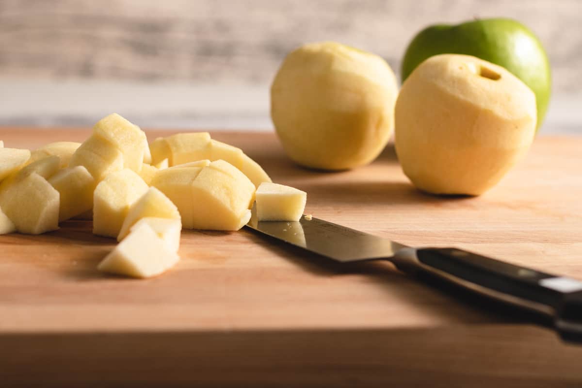 chopped Granny Smith apples on a wood cutting board