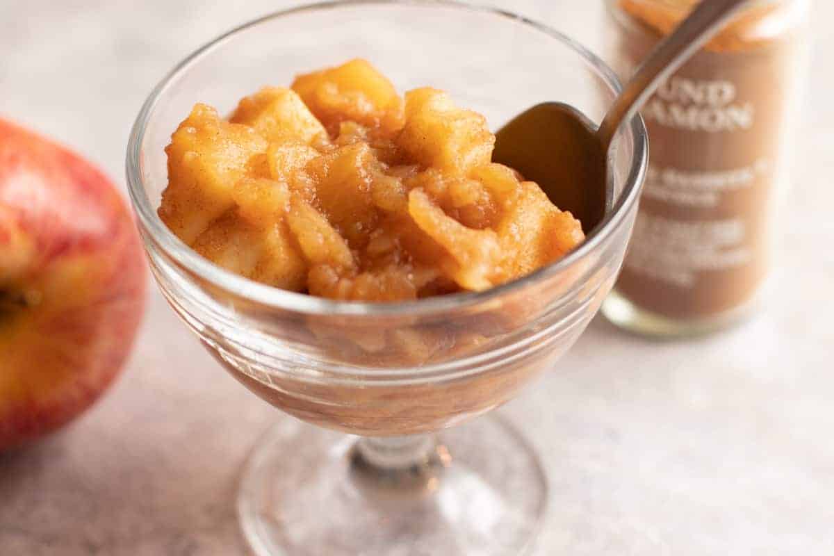 Cinnamon Maple Chunky Applesauce
in a glass cup with a spoon.