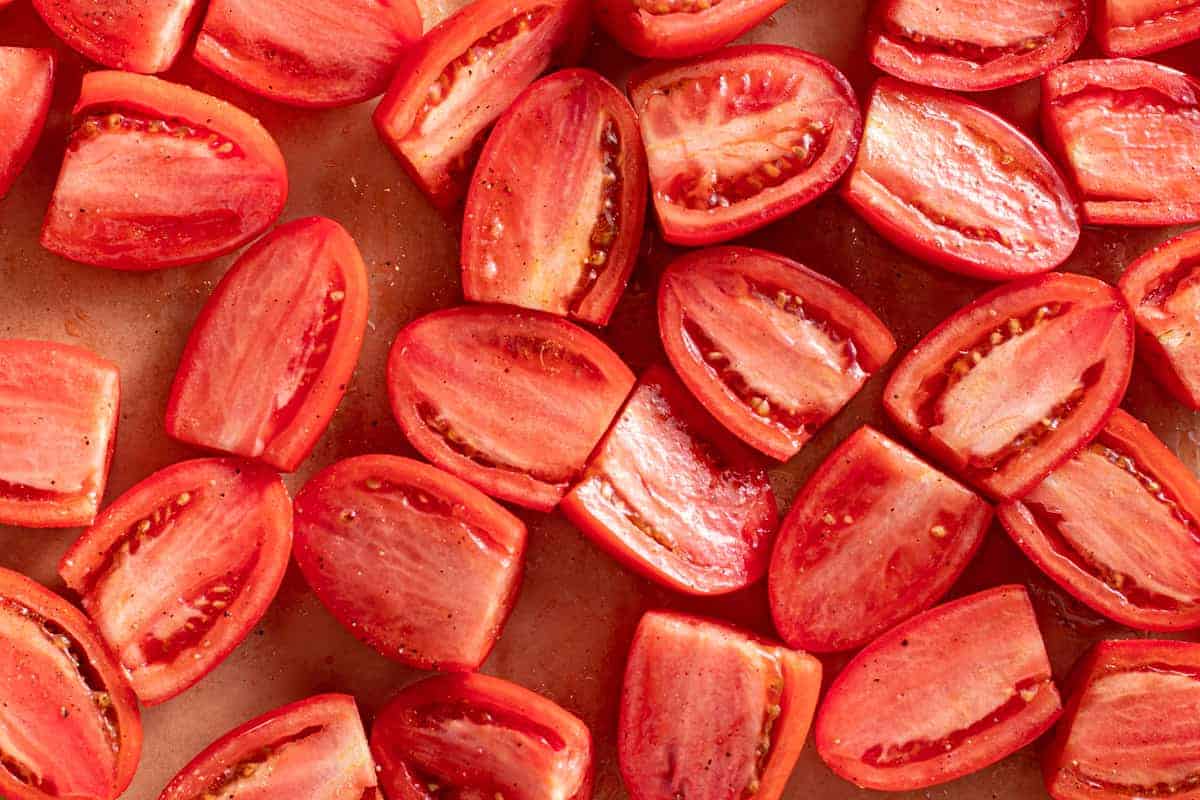 sliced roma tomatoes on sheet pan.