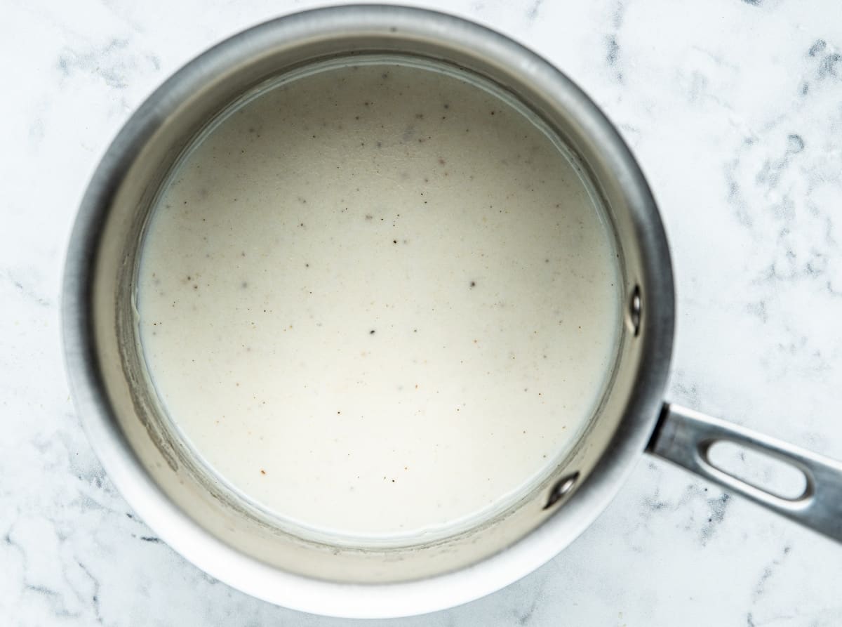 Bechamel sauce in a stainless steel pot. 