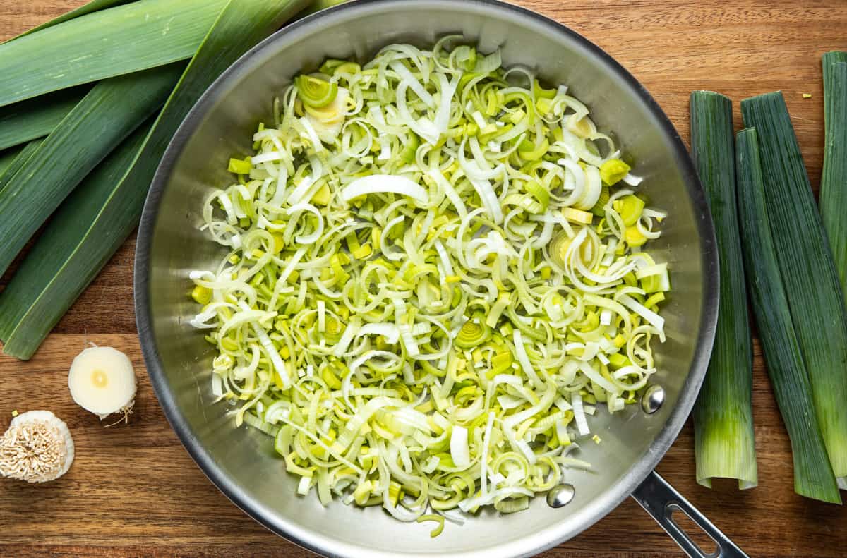 sliced leeks in a stainless steel pan ready to be cooked