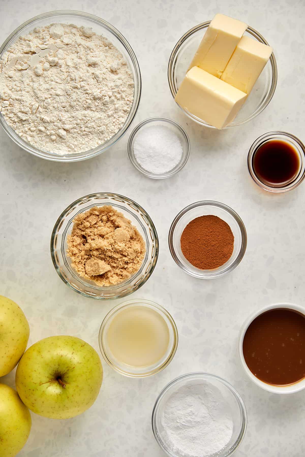 Ingredients in glass bowlsfor salted caramel apple pie bars 