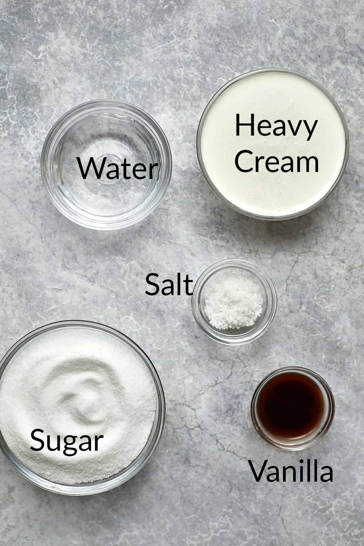 Ingredients for salted caramel sauce in clear bowls.