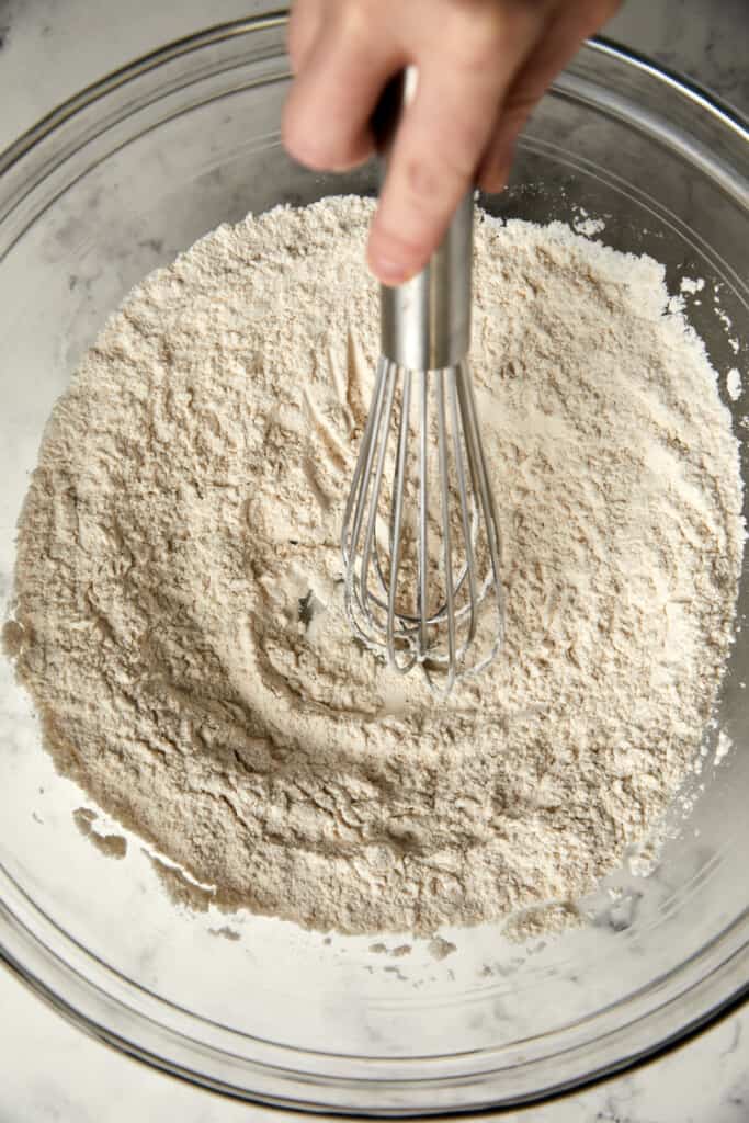 looking down at a glass bowl with dry ingredients whisked together.