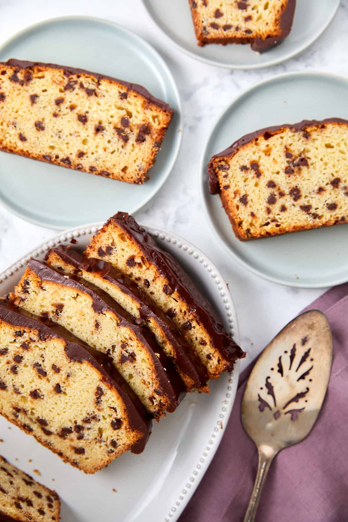 looking down on a baked chocolate chip loaf cake sliced on plates.