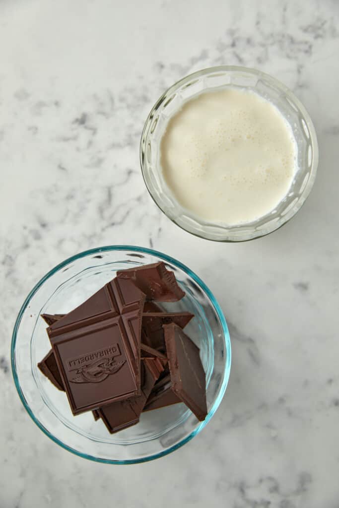 chocolate in glass bowl and cream in glass bowl.