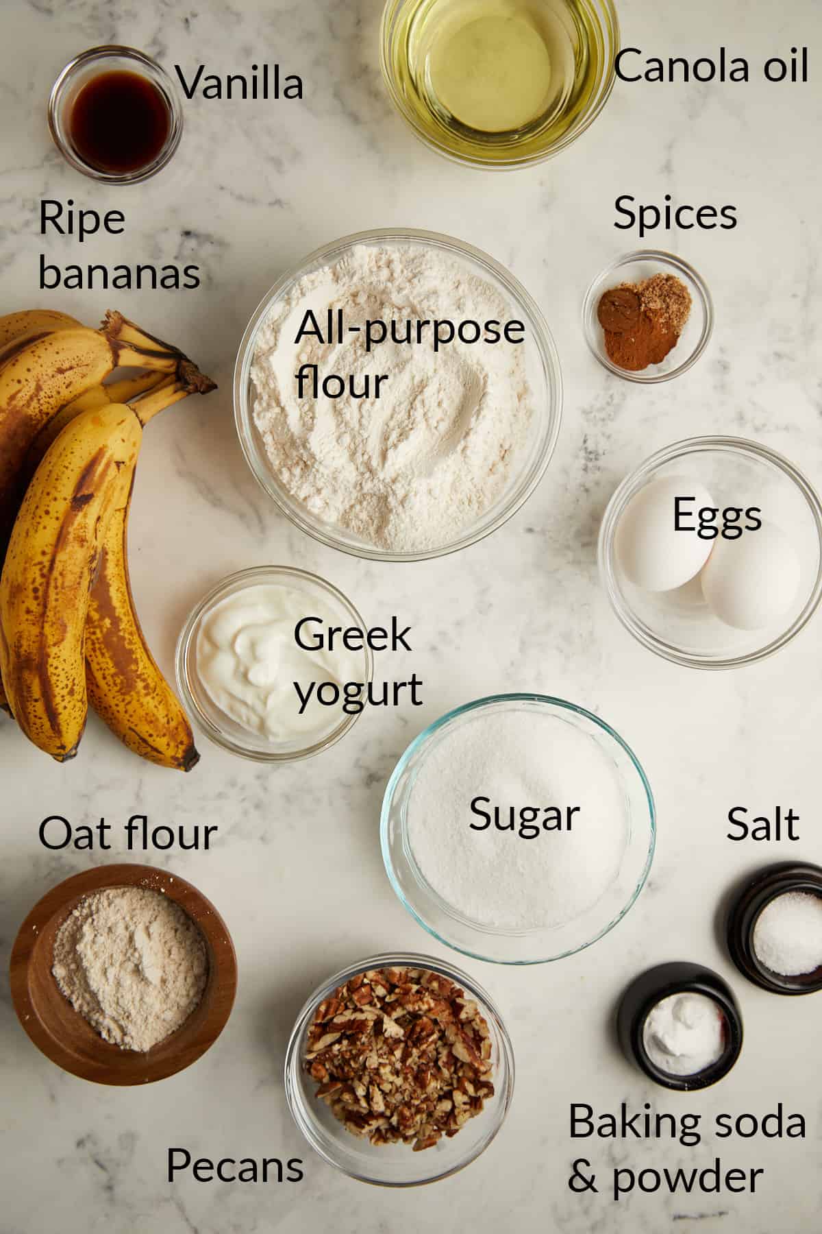 looking down at ingredients in bowls for banana bread with pecans. 