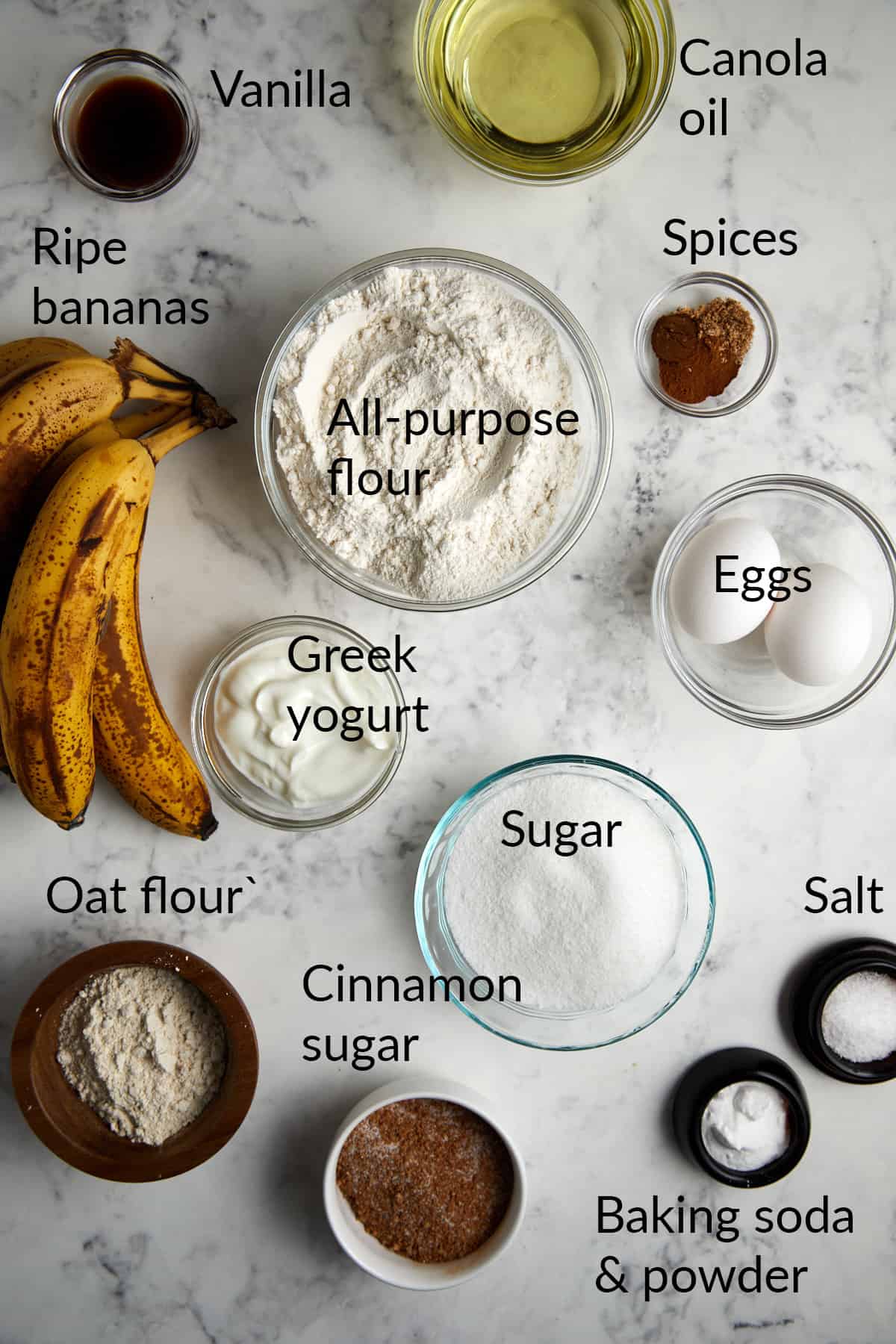 Looking down at the ingredients in bowls for cinnamon crunch banana bread.