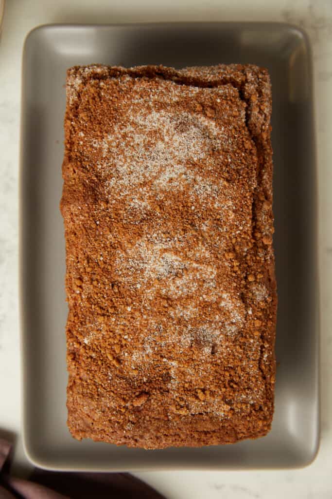 Looking down at cinnamon crunch banana bread on a gray platter.