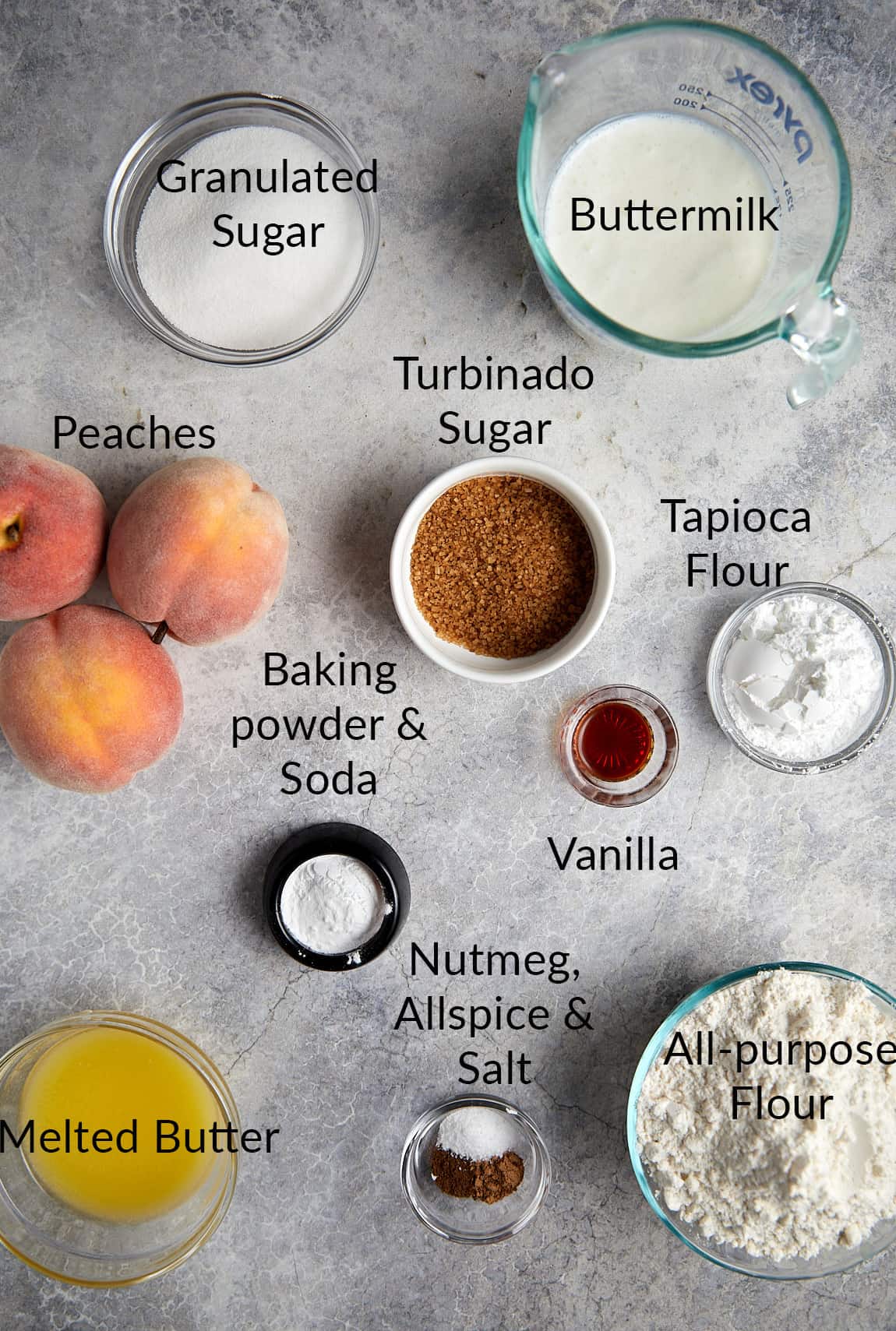 Overhead view of cast iron peach cobbler ingredients. 