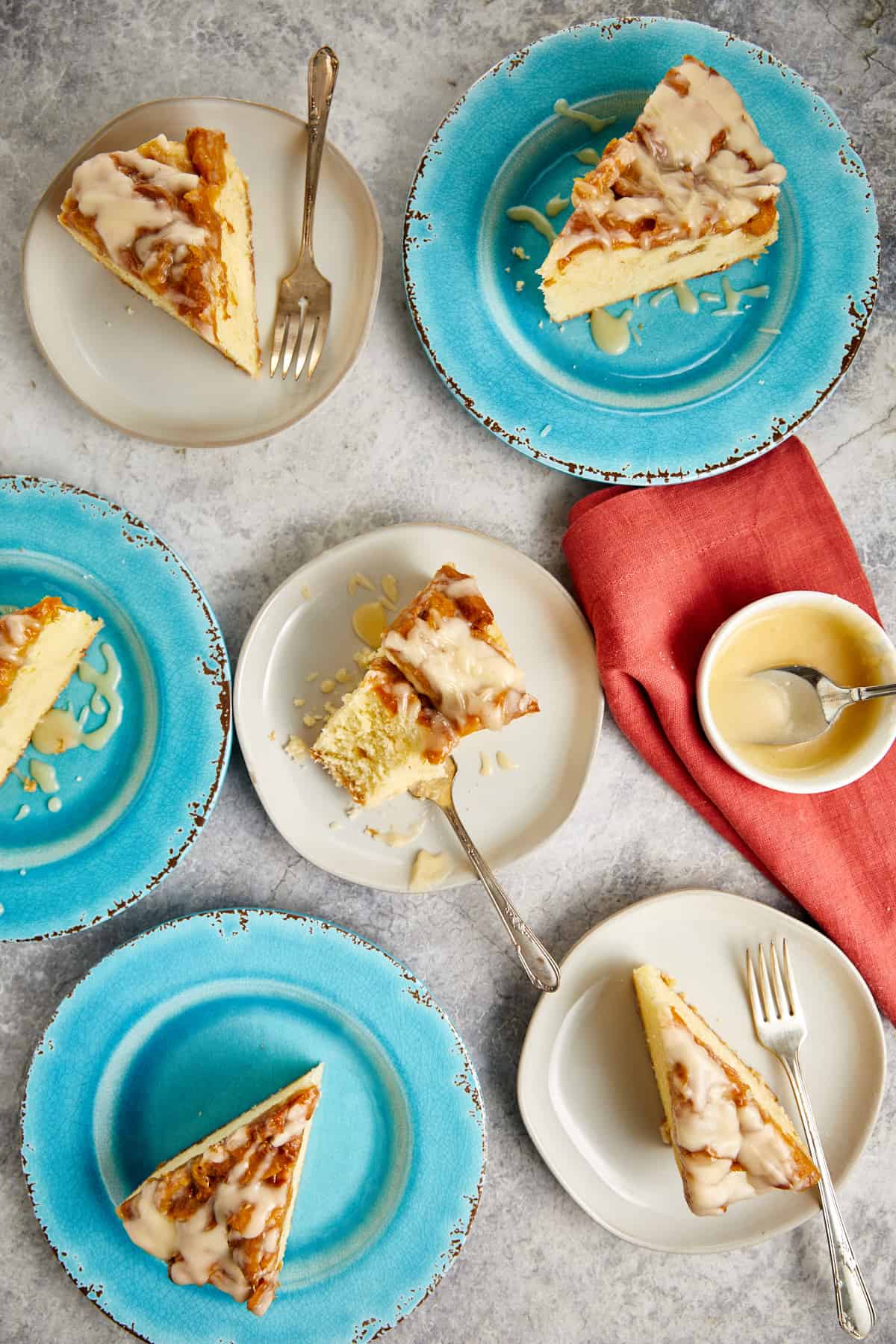 looking down at slices of peach cobbler pound cake on white and blue plates.