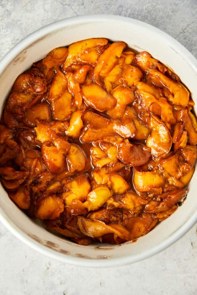 Looking down at sliced peaches in the baking pan.