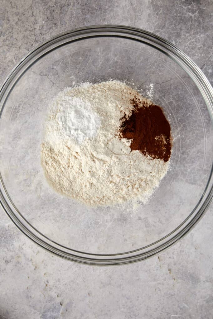 An overhead view of dry ingredients piled into a clear bowl.