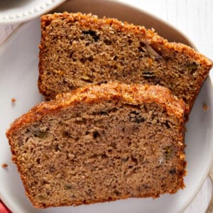 Overhead view of two slices of rhubarb banana bread on a small white plate.