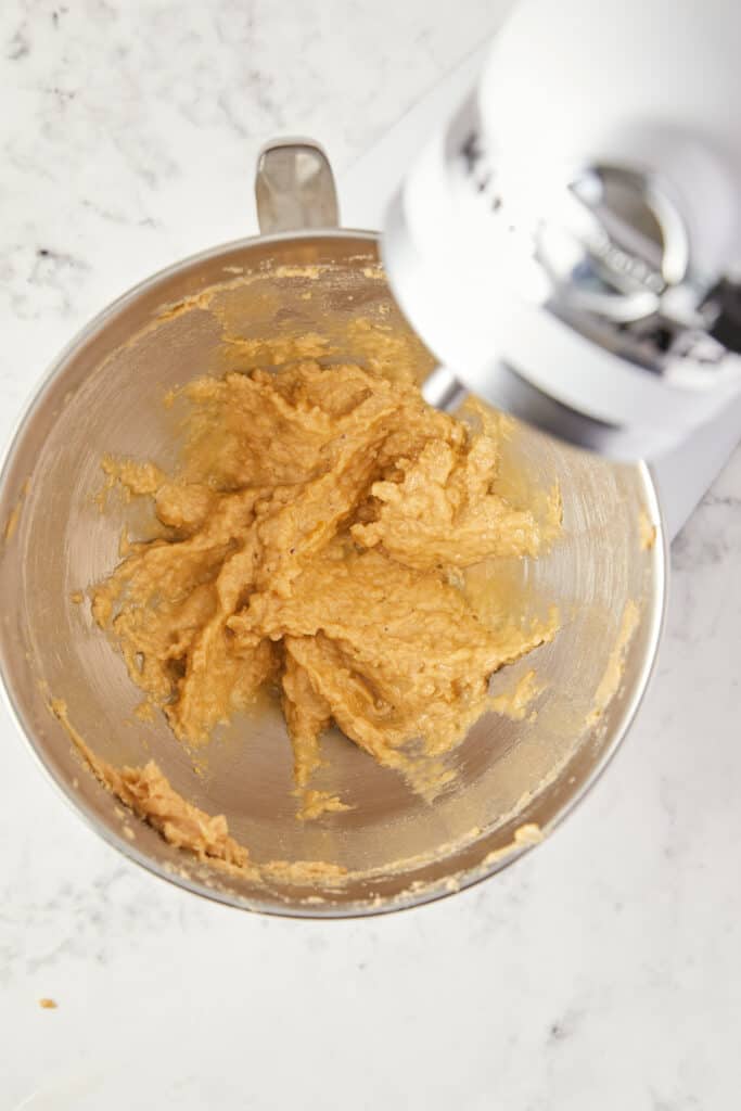 overhead view of butter sugar and egg mixed in the mixer bowl.