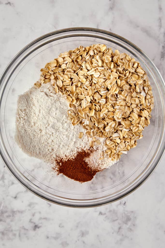 overhead view of dry ingredients piled into glass bowl.