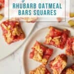 overhead view of rhubarb oatmeal squares on white plates.