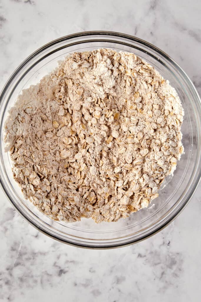 Overhead view of dry ingredients mixed in a glass bowl.