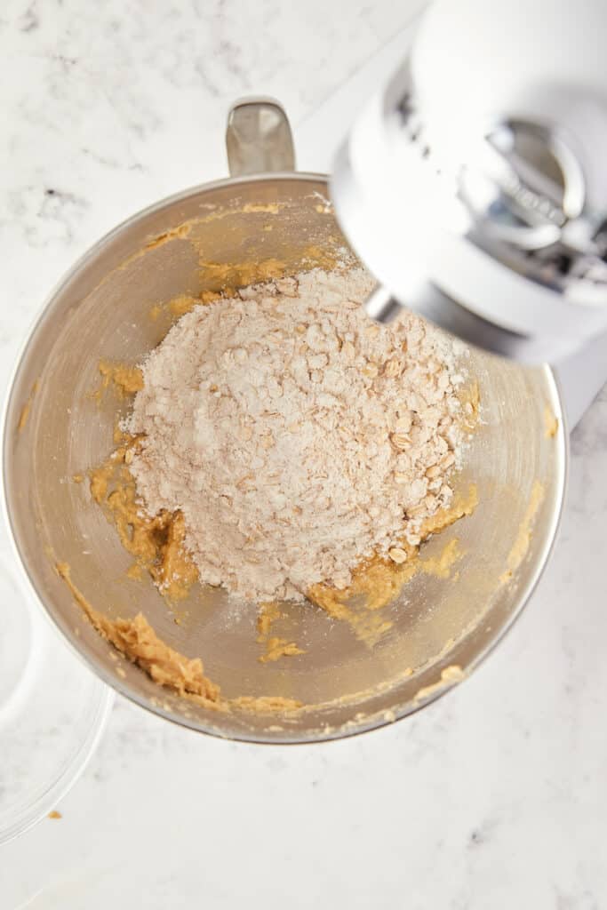 overhead view of dry ingredients added to the butter and brown sugar mixture.