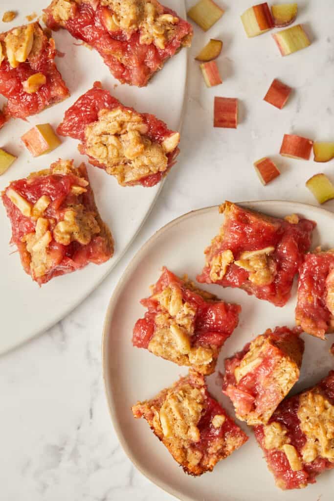 overhead view of rhubarb oatmeal squares on white plates