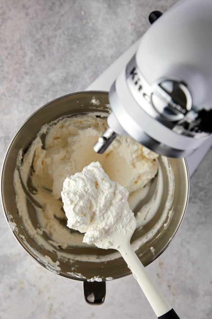 Overhead view with heaving cream with whipped cream on a spatula.