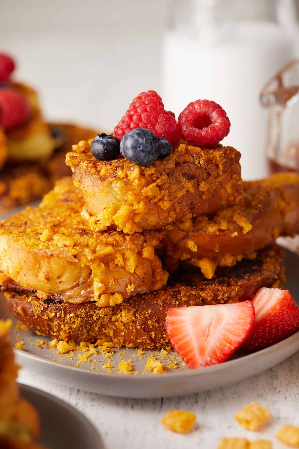 Close-up view of Captain Crunch French toast stacked on top of a plate.