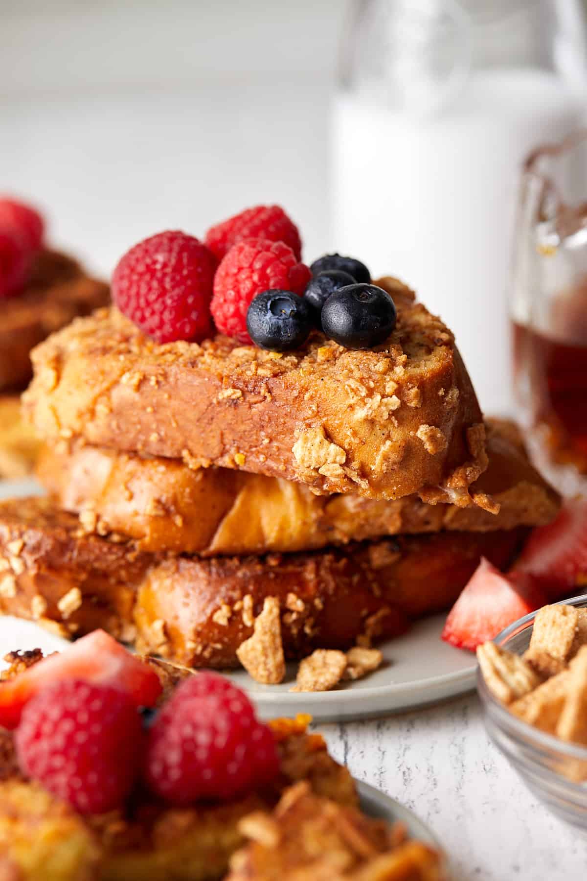 Close up view of cinnamon toast crunch french toast with fruit on top. 
