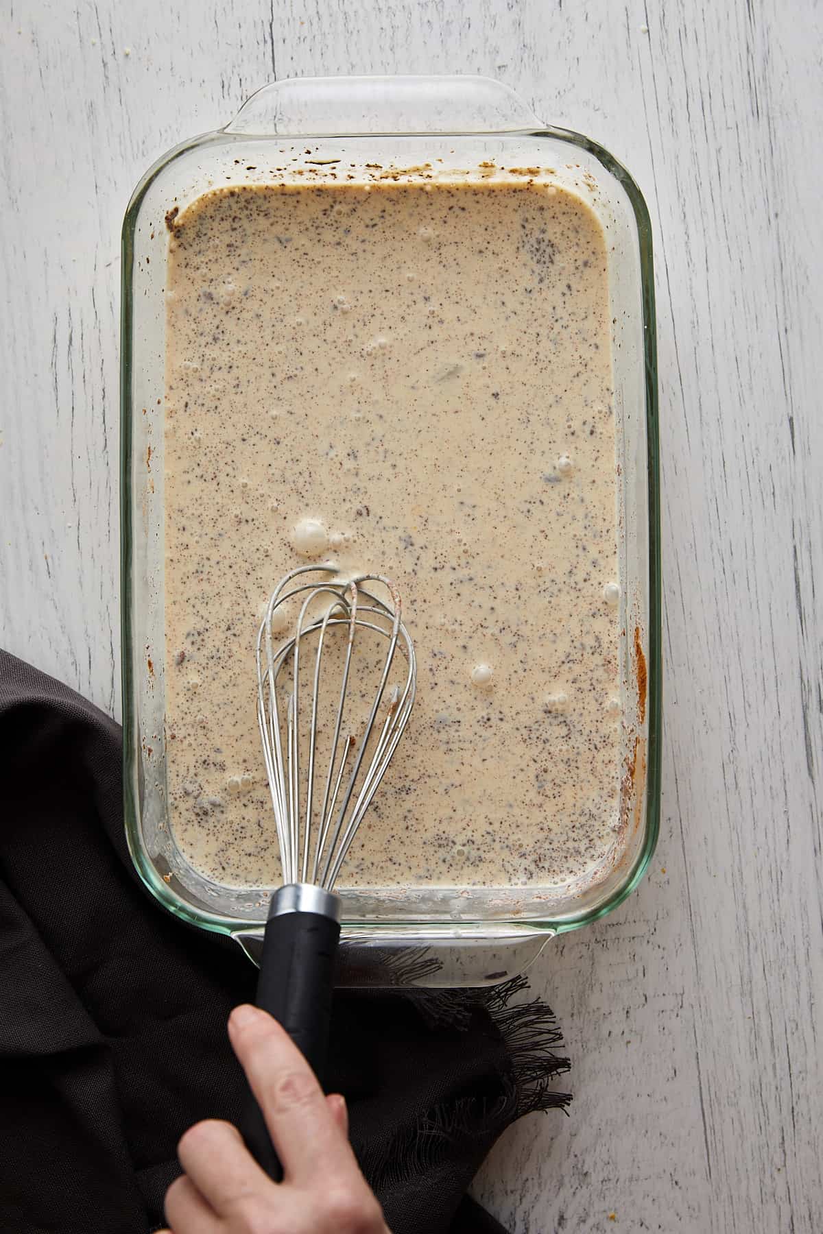 Overhead view of custard fully mixed in a glass dish.