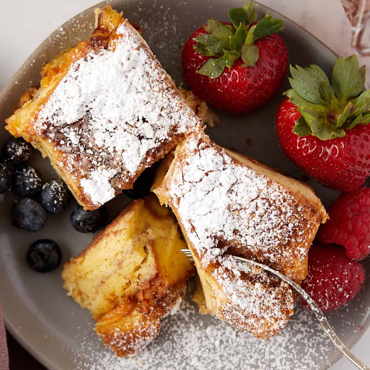 Overhead view of brioche french toast casserole with fork in a bite.