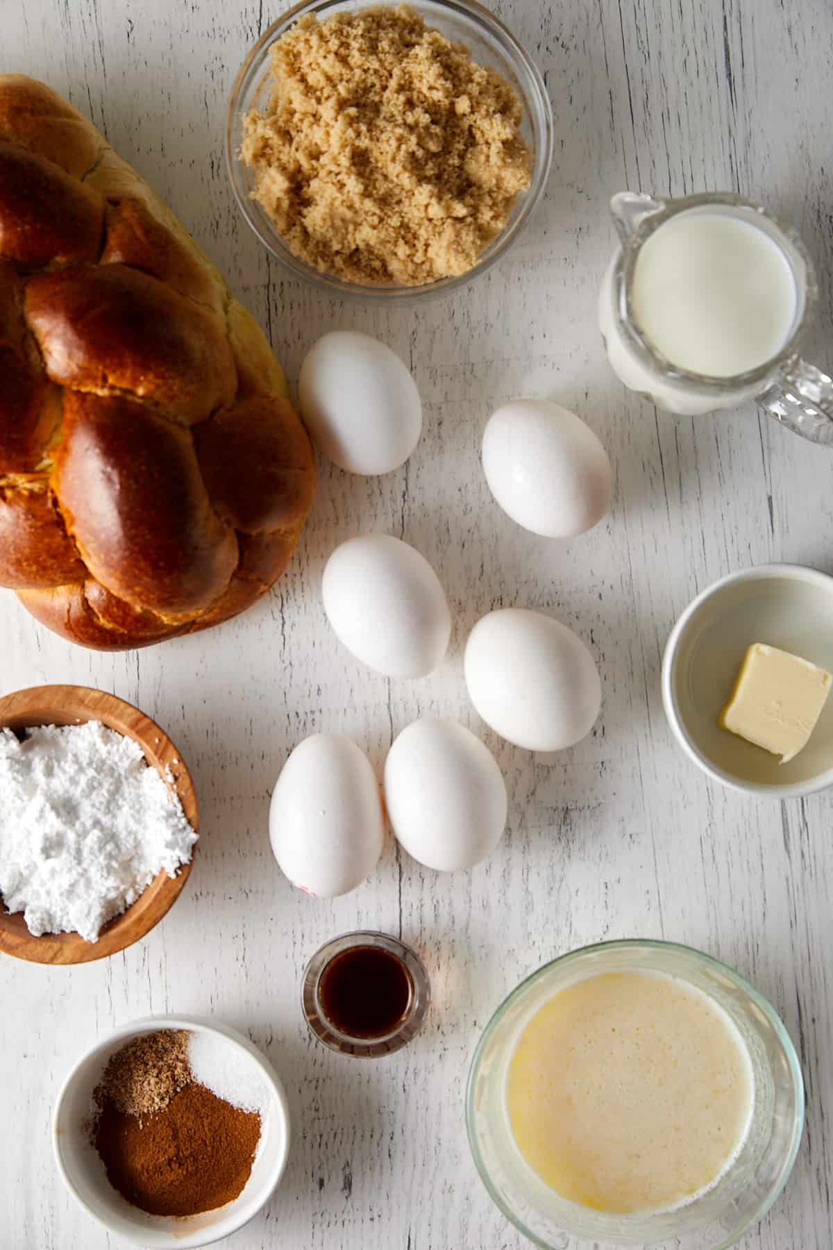 A variety of ingredients including eggs, milk, and cinnamon for the Challah French Toast Casserole.