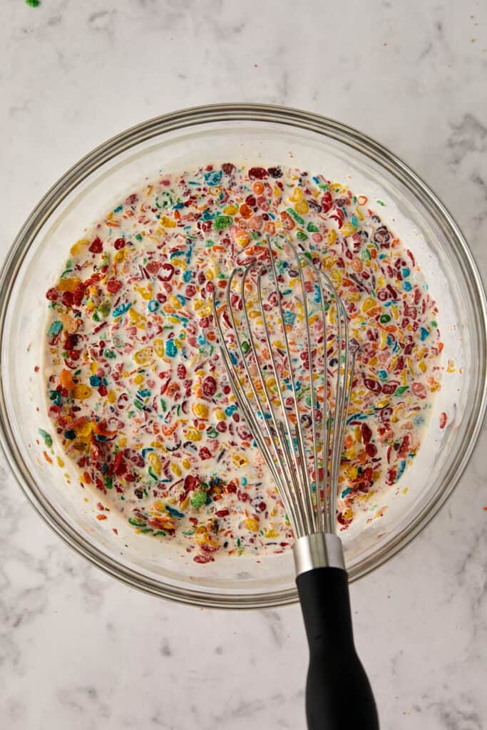 Overhead view of Fruity pebbles mixed in the milk.