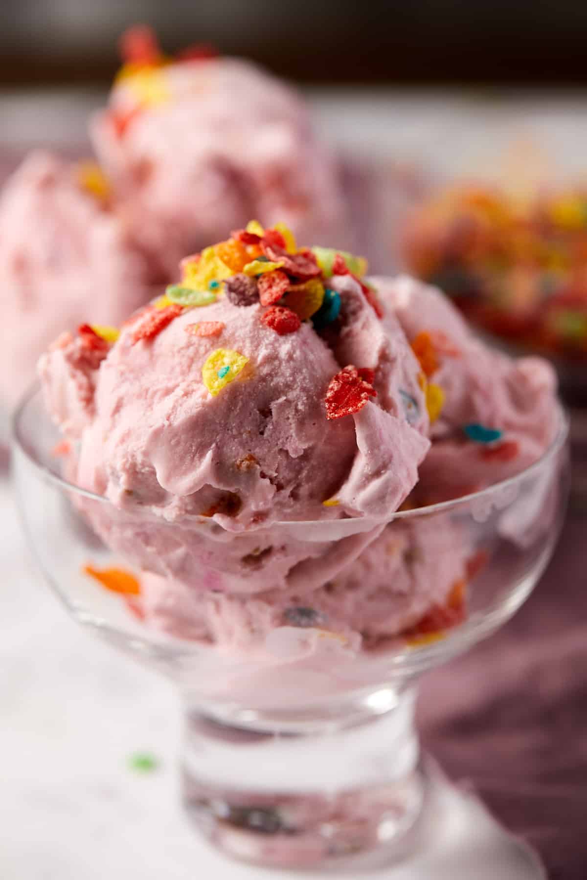 Scoops of fruity pebble ice cream in a small bowl.