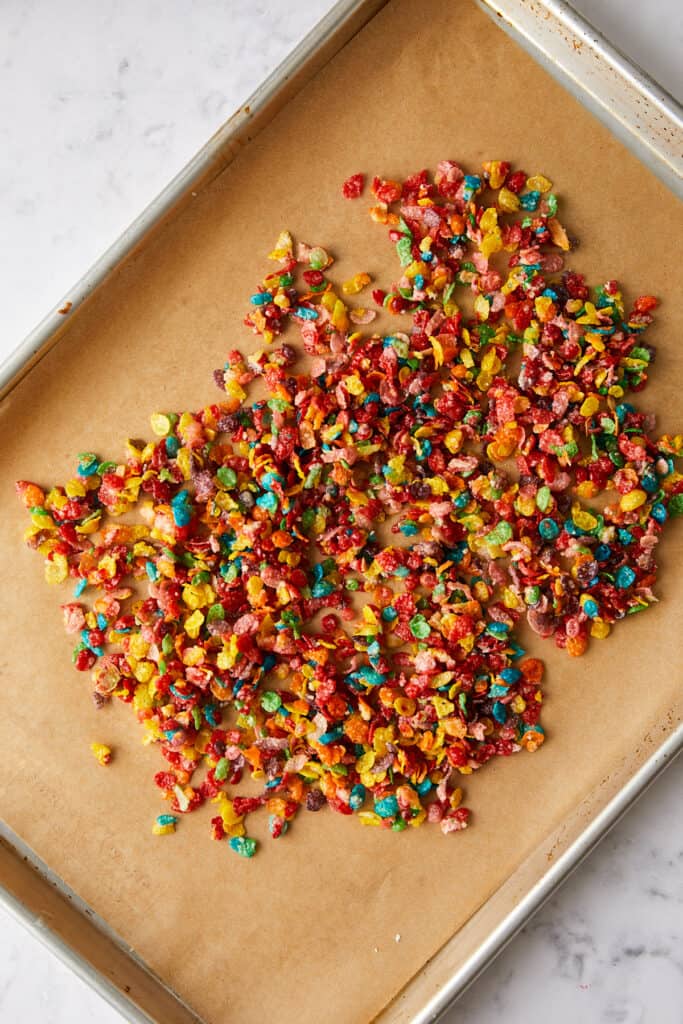 Fruity pebbles crunch mixture on a sheet pan.