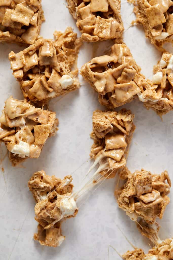 Overhead view of cut cinnamon toast crunch marshmallow treats. 