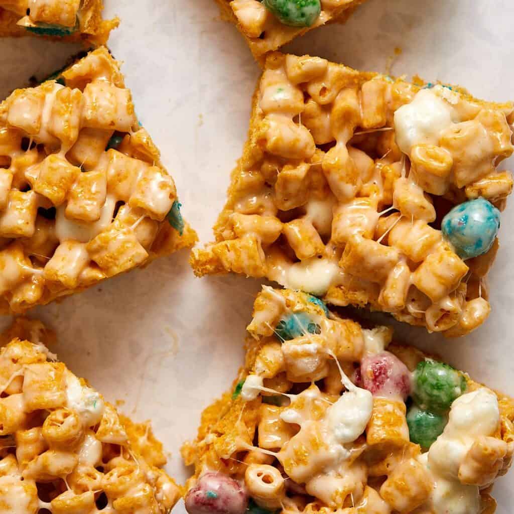 Close-up of Captain Crunch marshmallow treats, cut into chewy squares and placed on a light surface. 
