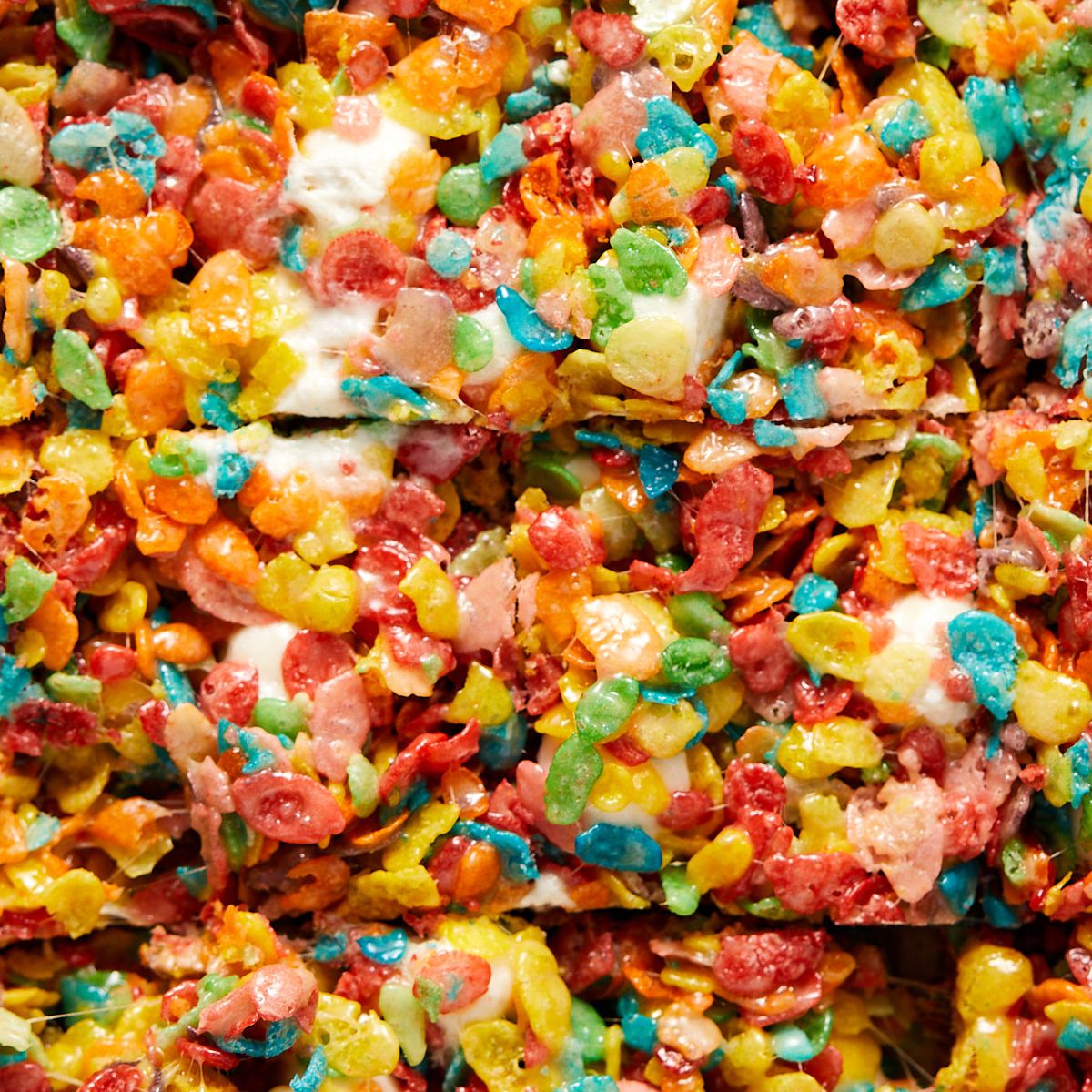 Close-up of fruity pebbles rice krispie treats cut into squares.