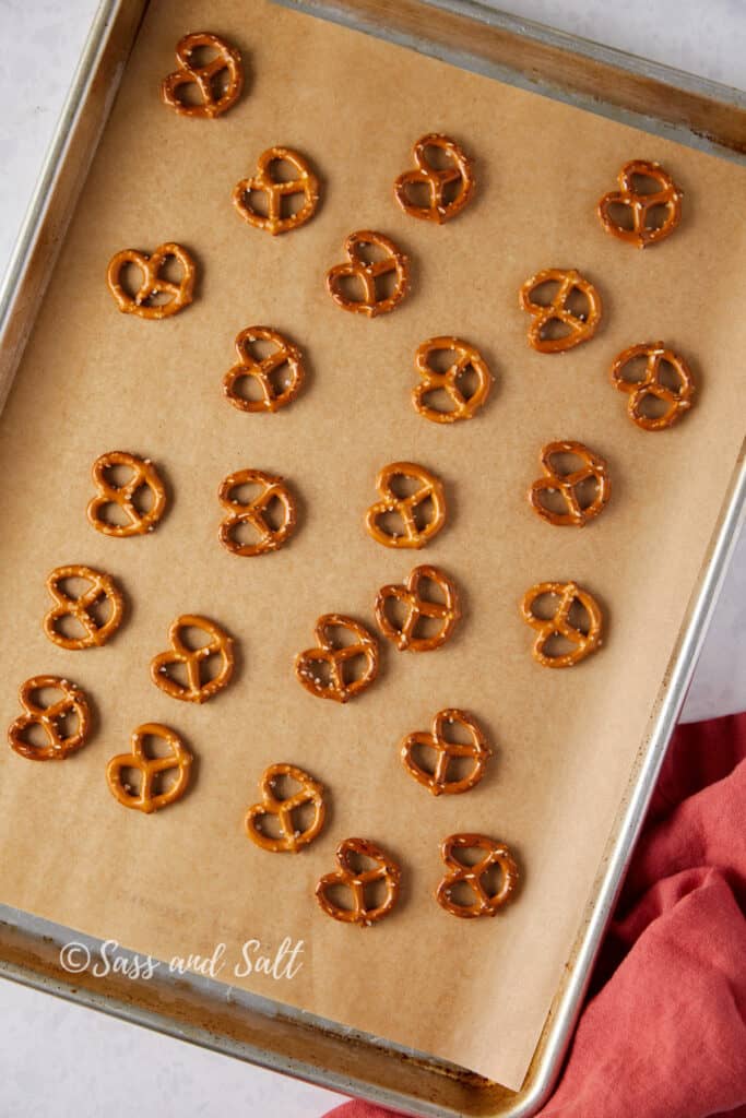 Pretzels spread out on a sheet pan.