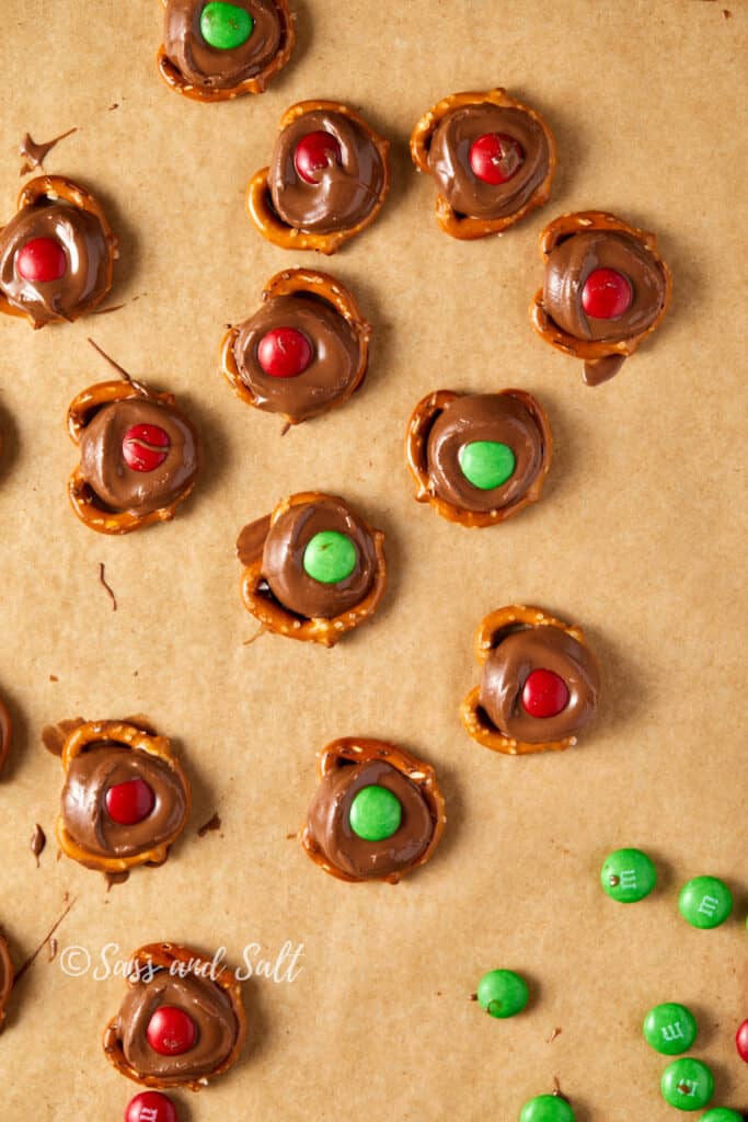 Overhead close-up of Rolos on pretzels with Green and Red M&M's pressed into the Rolos.
