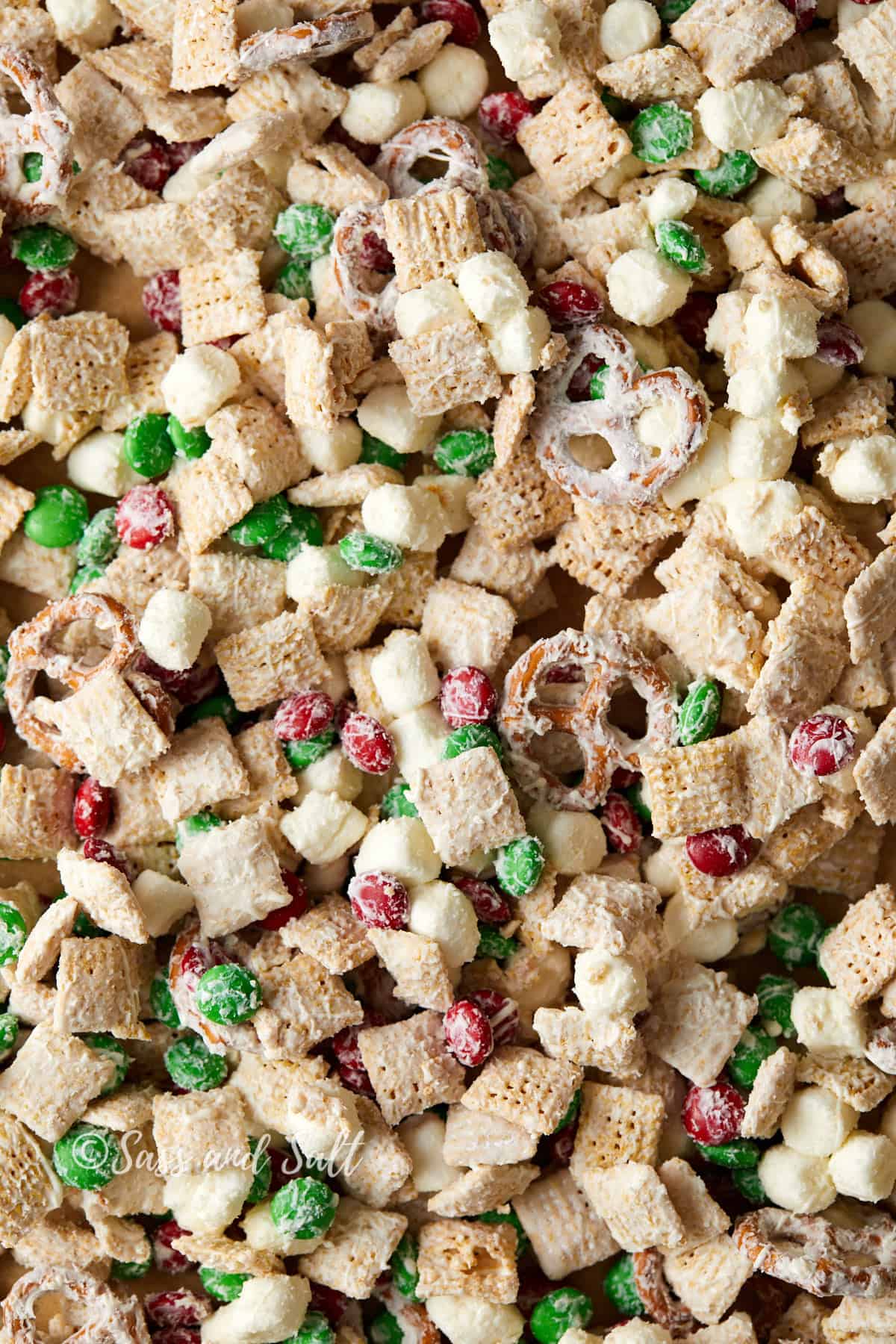 Overhead close up view of white chocolate Chex mix with M&M's.