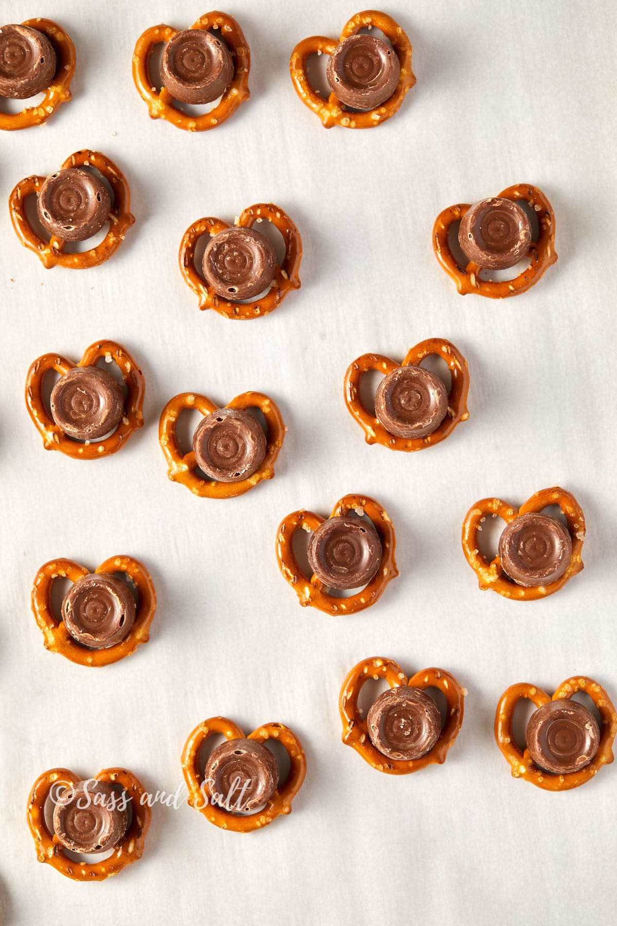 Overhead view of pretzels with Rolos on top of pretzels.