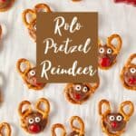 Overhead view of homemade Rolo pretzel reindeer treats with antlers, eyes, and red noses.