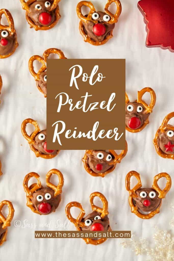 Overhead view of homemade Rolo pretzel reindeer treats with antlers, eyes, and red noses.