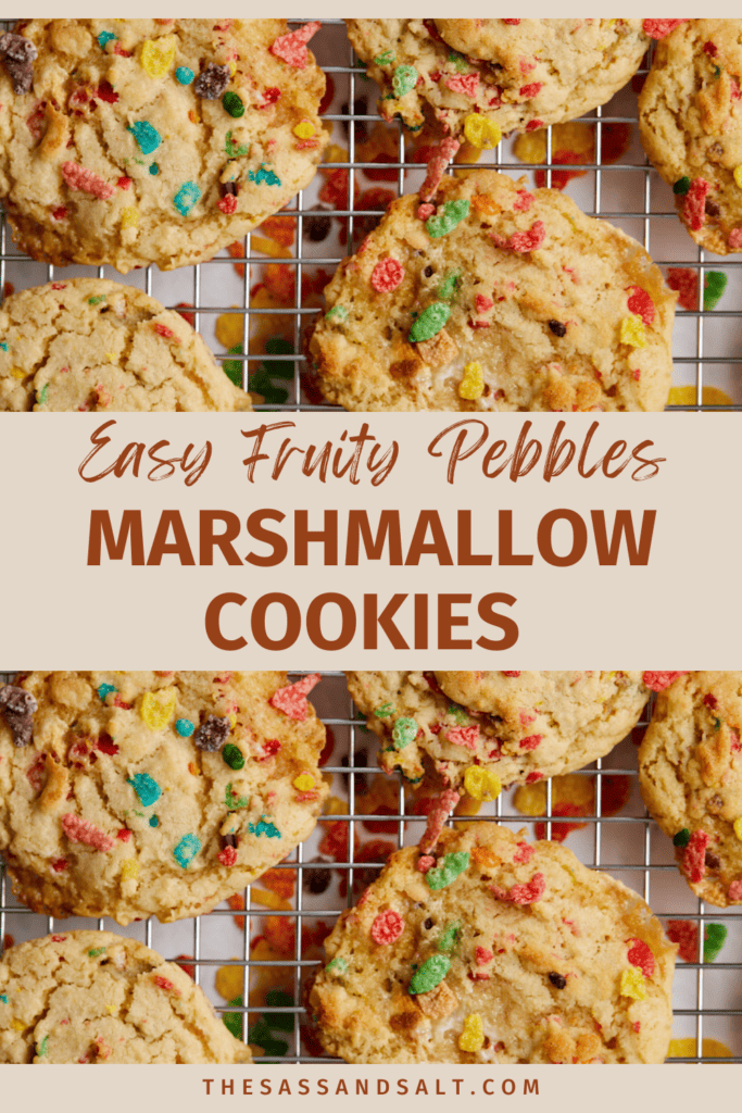 The image features a graphic design intended as a digital pin or blog post header, showcasing freshly baked Fruity Pebble Marshmallow Cookies. The cookies, studded with bright, colorful bits of Fruity Pebbles cereal, are displayed on a wire cooling rack, suggesting they have just come out of the oven. The text overlay, in a friendly and inviting script font, reads "Easy Fruity Pebbles Marshmallow cookies.