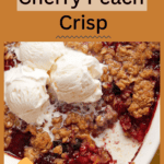 A cherry peach crisp topped with scoops of vanilla ice cream, featuring a golden-brown crumble topping and vibrant red fruit filling, served in a baking dish. the image includes the text "delicious cherry peach crisp" and the website "thesassandsalt.com".