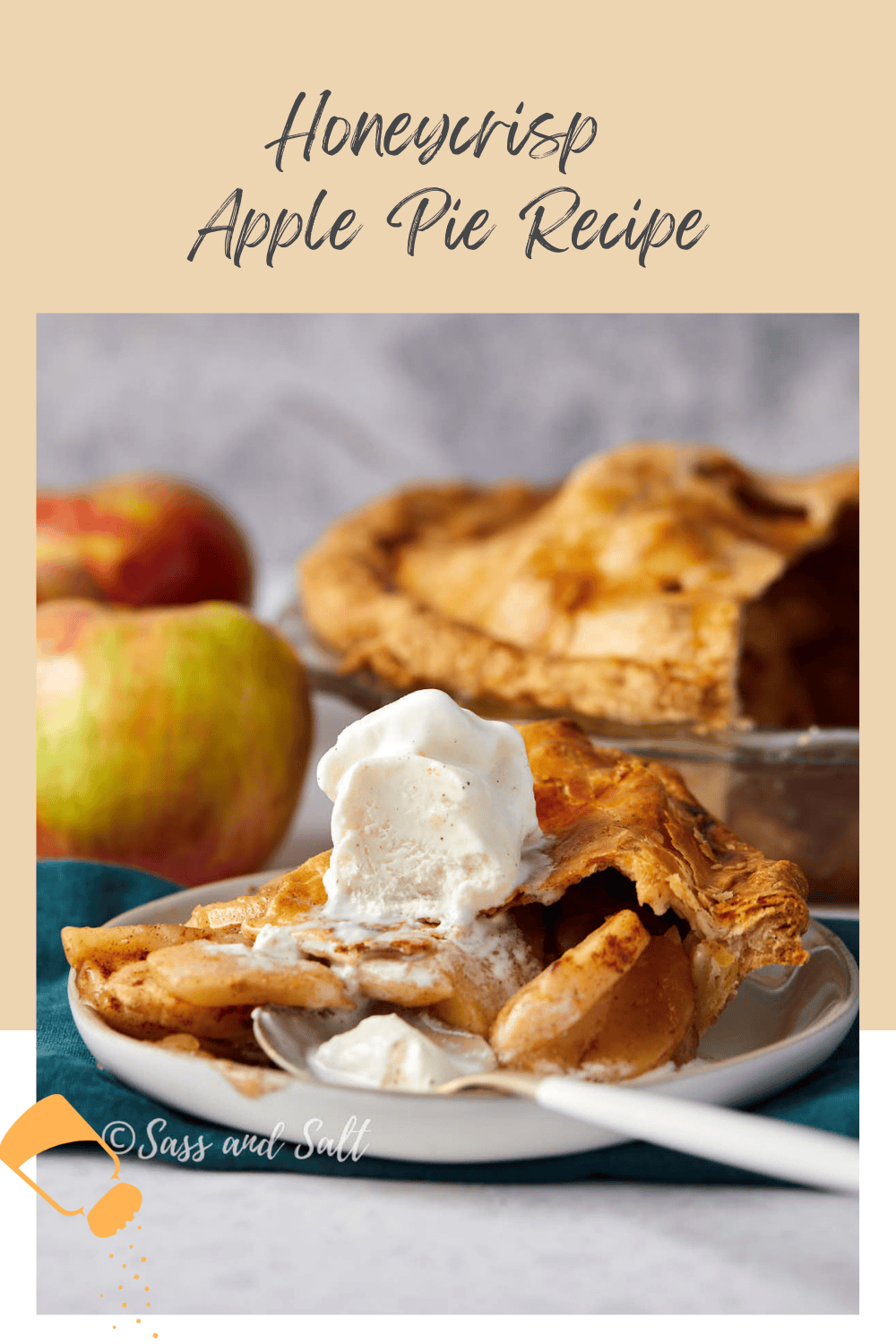 A slice of apple pie with a scoop of vanilla ice cream sits on a white plate. The pie is made with Honeycrisp apples. In the background, a whole pie and fresh apples are visible. The text reads "Honeycrisp Apple Pie Recipe.