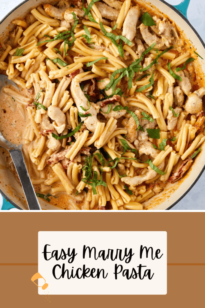 A skillet of creamy pasta with sliced chicken, garnished with fresh basil. A spoon is resting in the dish. The text on the image reads "Easy Marry Me Chicken Pasta.