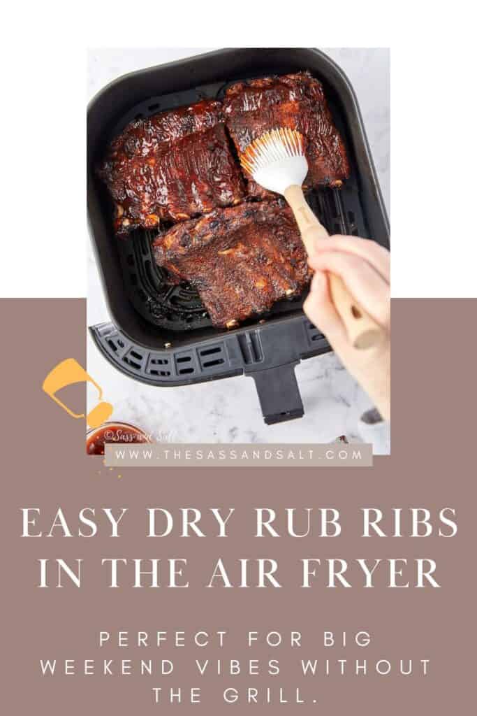 A hand uses a brush to apply sauce on dry rub ribs in an air fryer. The image is part of a recipe titled "Easy Dry Rub Ribs in the Air Fryer," highlighting its suitability for weekend meals without grilling.