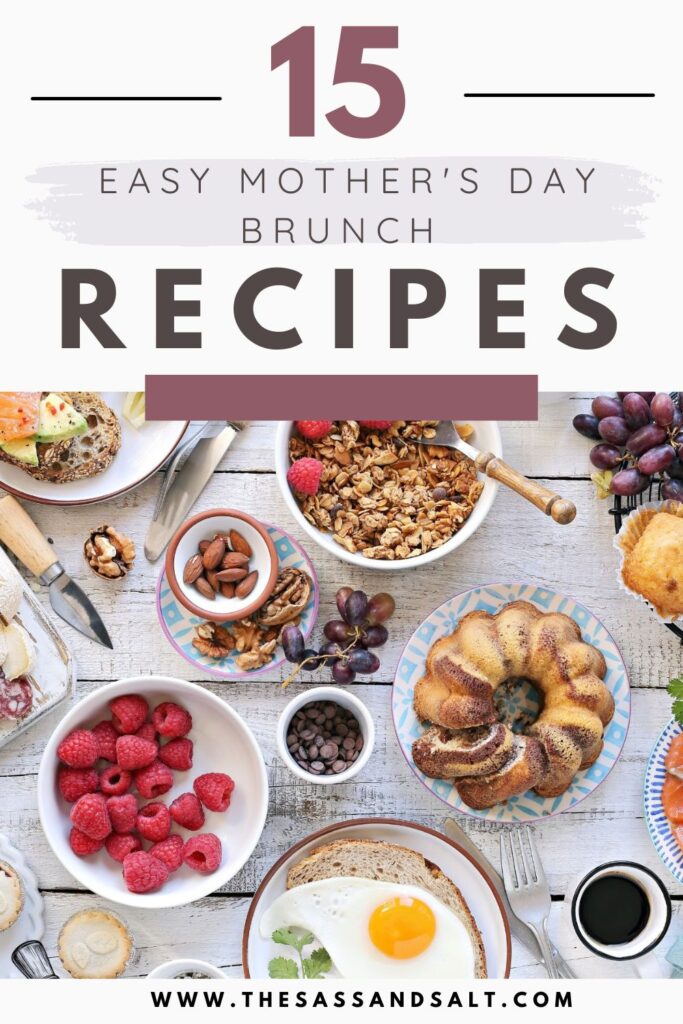 A brunch table filled with berries, granola, grapes, bundt cake, toast, nuts, and a fried egg highlights 15 easy Mother's Day brunch recipes from thesassandsalt.com.