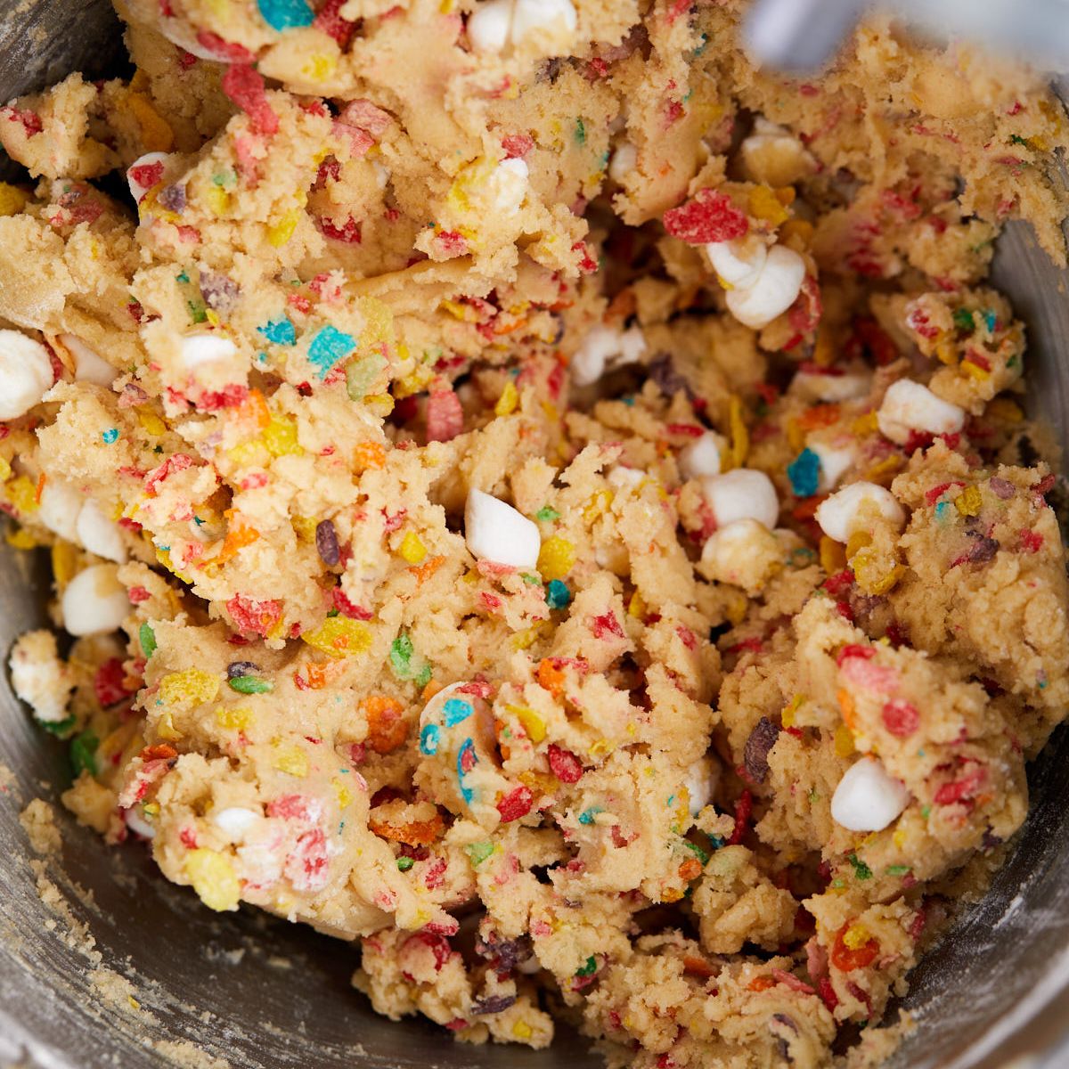 Fruity Pebbles cereal and mini marshmallows folded into the cookie dough.