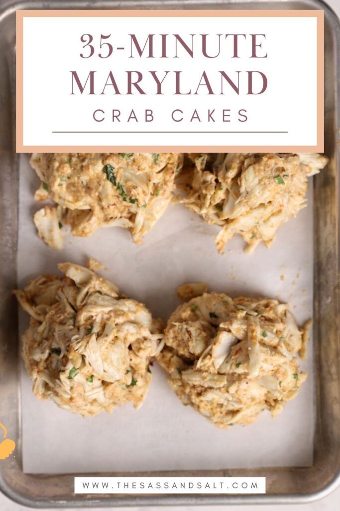 Four uncooked crab cakes sit on a metal baking tray. Above them, text reads: "35-Minute Maryland Crab Cakes." A website, "thesassandsalt.com," appears at the bottom of the image.